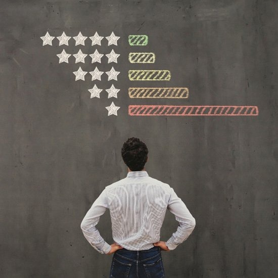 Man looking at a ratings chalkboard
