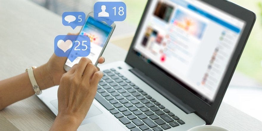 Phone and laptop showing social media notification icons