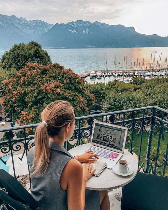 Woman using a laptop on a balcony
